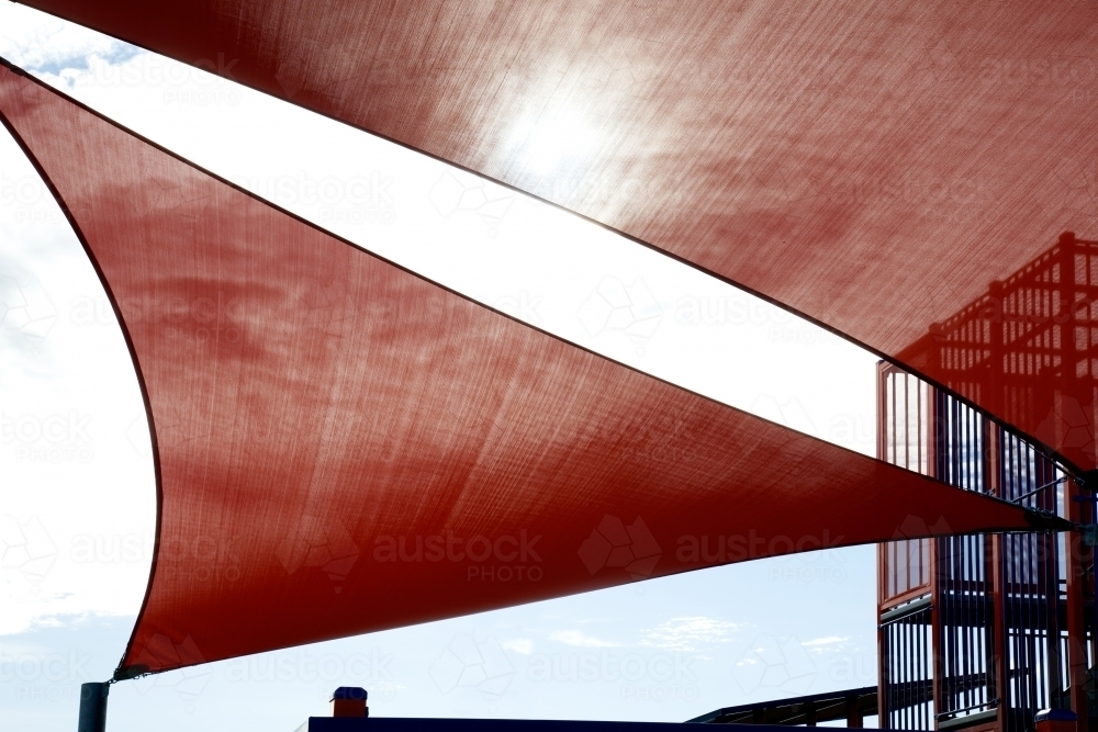 Red shade sail above kid's playground - Australian Stock Image