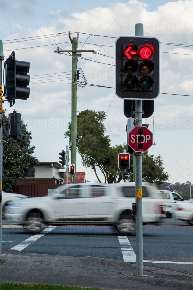 Red traffic light and stop sign at intersection in Newcastle - Australian Stock Image