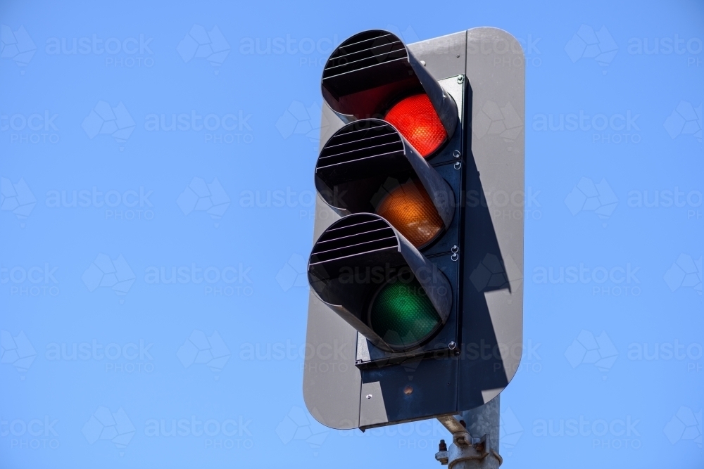 Red traffic lights in the blue sky background - Australian Stock Image