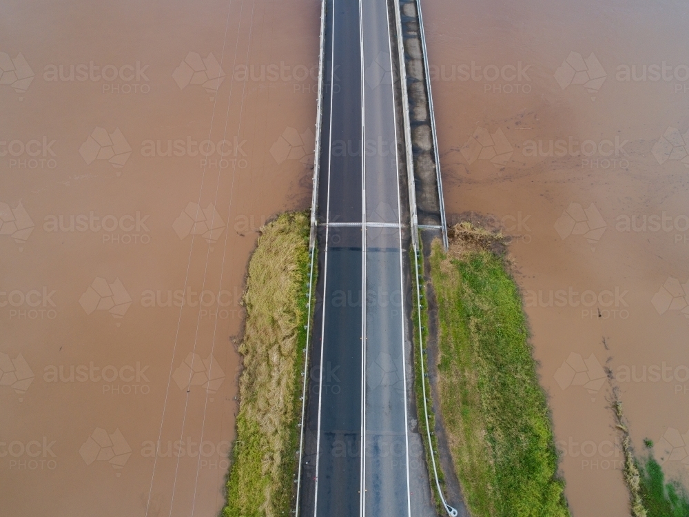 Redbournberry bridge near Singleton surrounded by floodwater during natural disaster of flood - Australian Stock Image