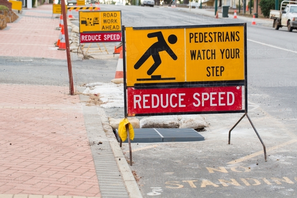 Reduce speed sign on street warning of road works - Australian Stock Image