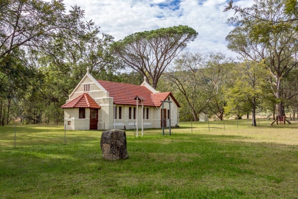 Reedy Creek Country Church among trees in the distance - Australian Stock Image