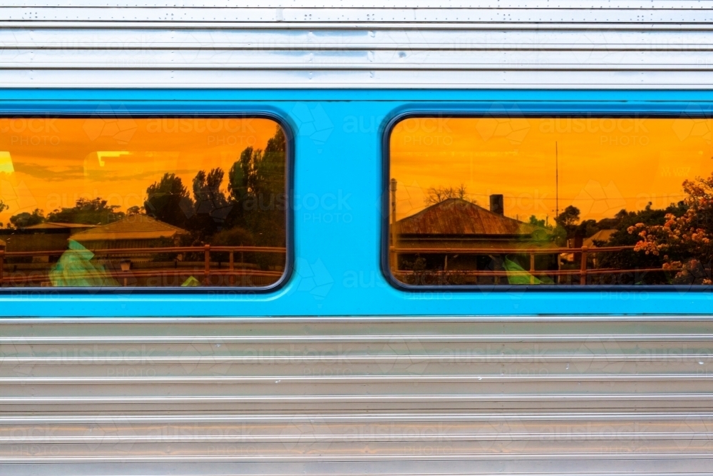 Reflection of a house in the window of a passing train - Australian Stock Image