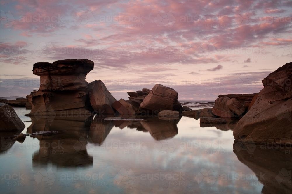 Reflection of rocks at the beach - Australian Stock Image