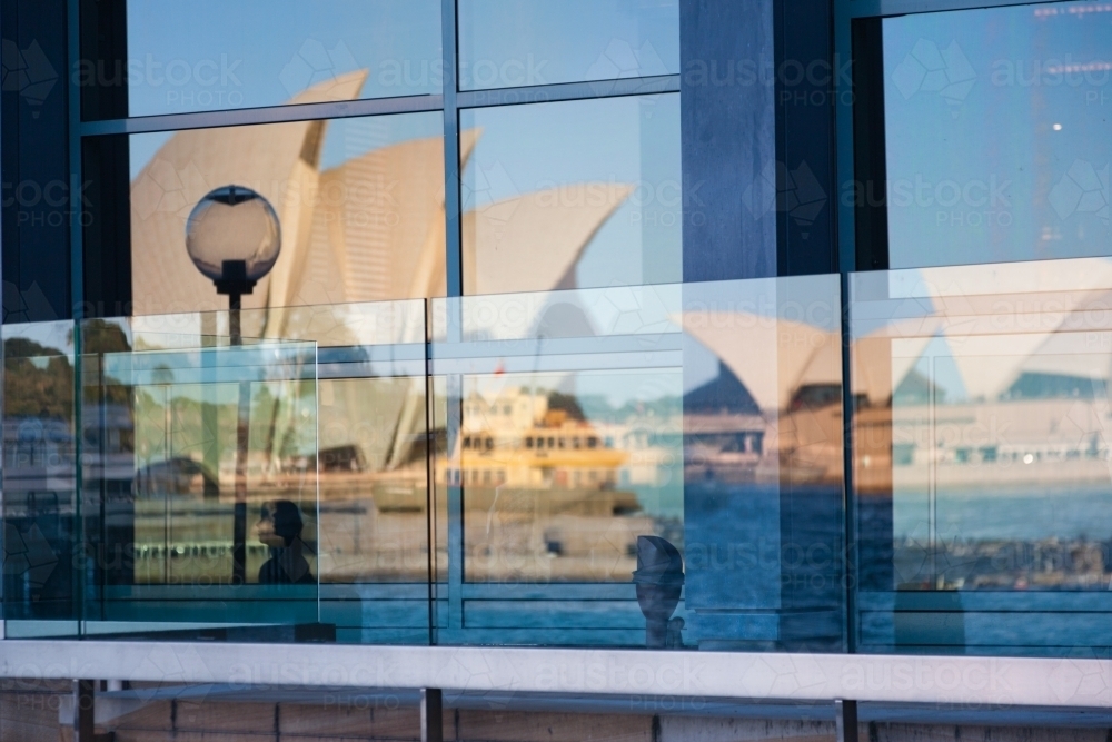 Reflection of the opera house and sydney ferry in windows at circular quay, sydney - Australian Stock Image