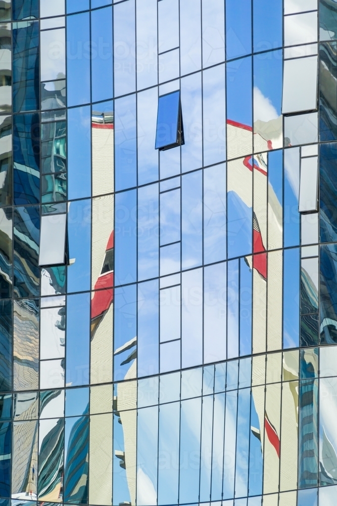 Reflections in the glass windows on the side of a building - Australian Stock Image