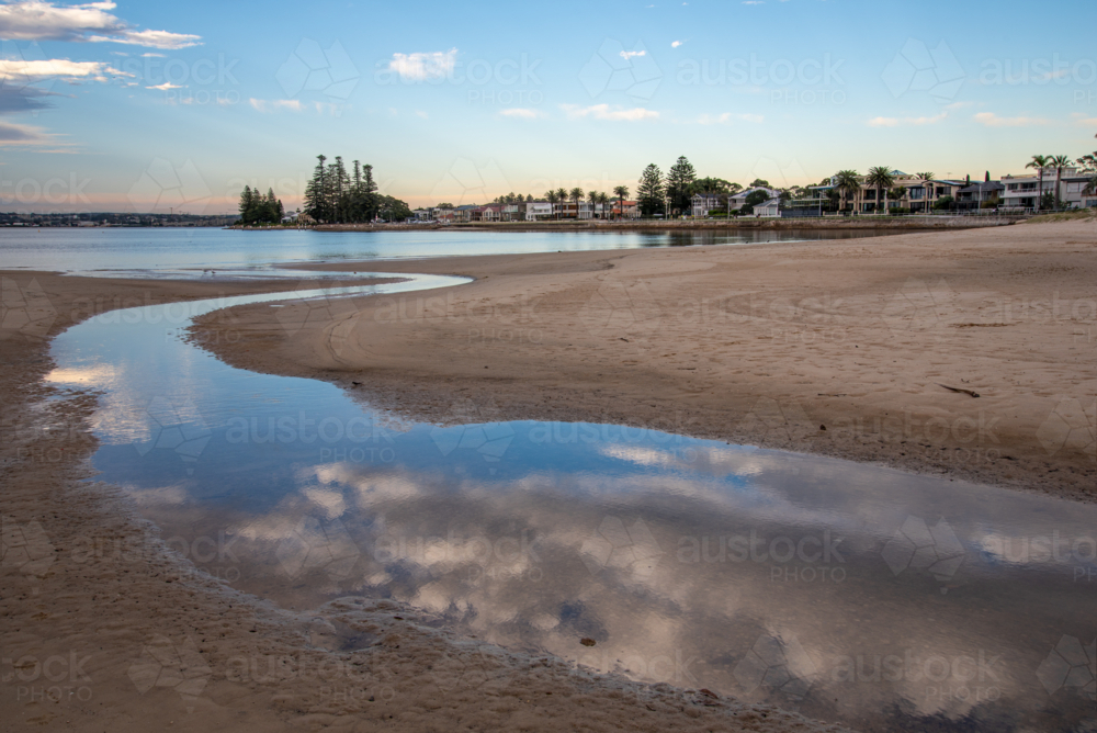 Reflections of clouds in water at Lady Robinsons Beach - Australian Stock Image