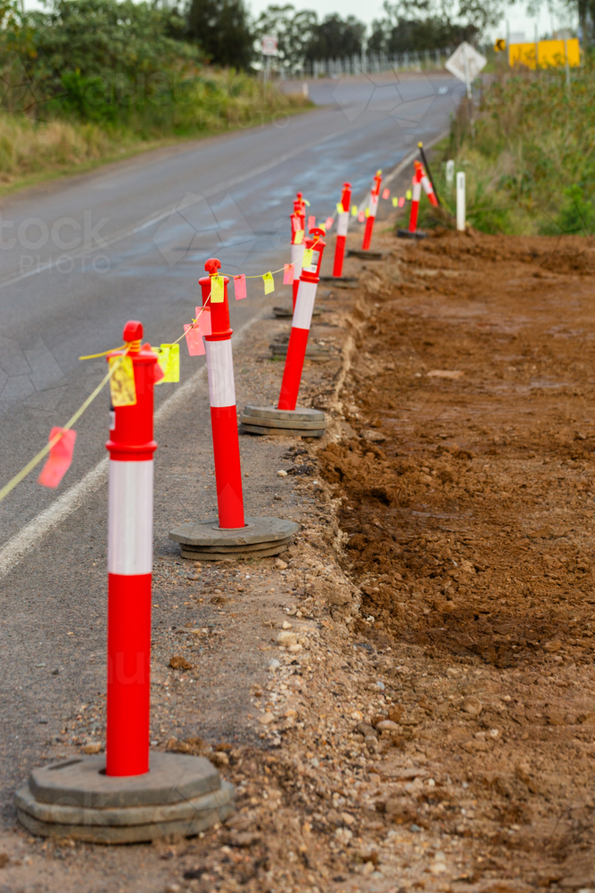 Reflective tags on worksite fence beside road - Australian Stock Image