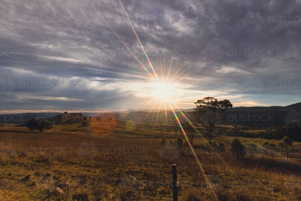 Regional NSW sunset landscape with vibrant sunburst - Australian Stock Image