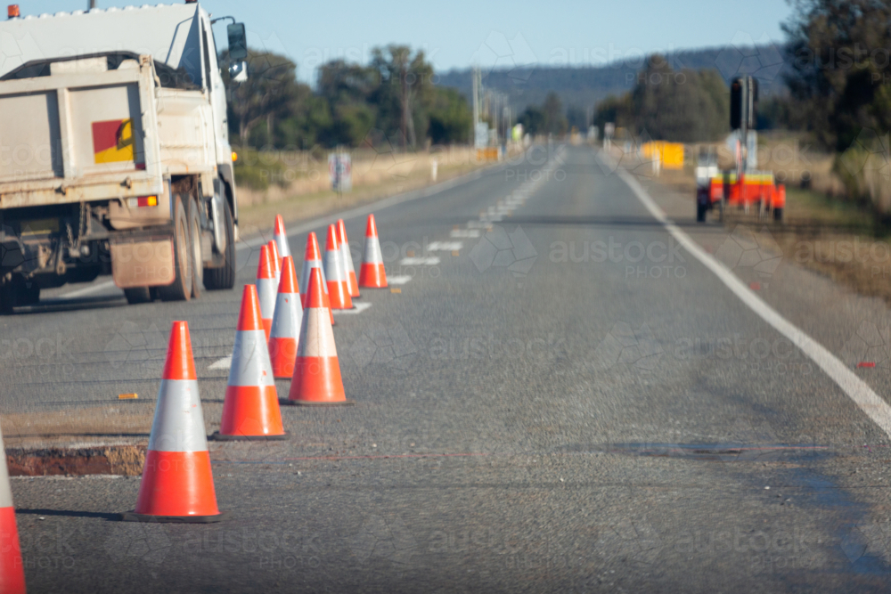 Regional road with witches hat cones for roadwork, repairing the road - Australian Stock Image