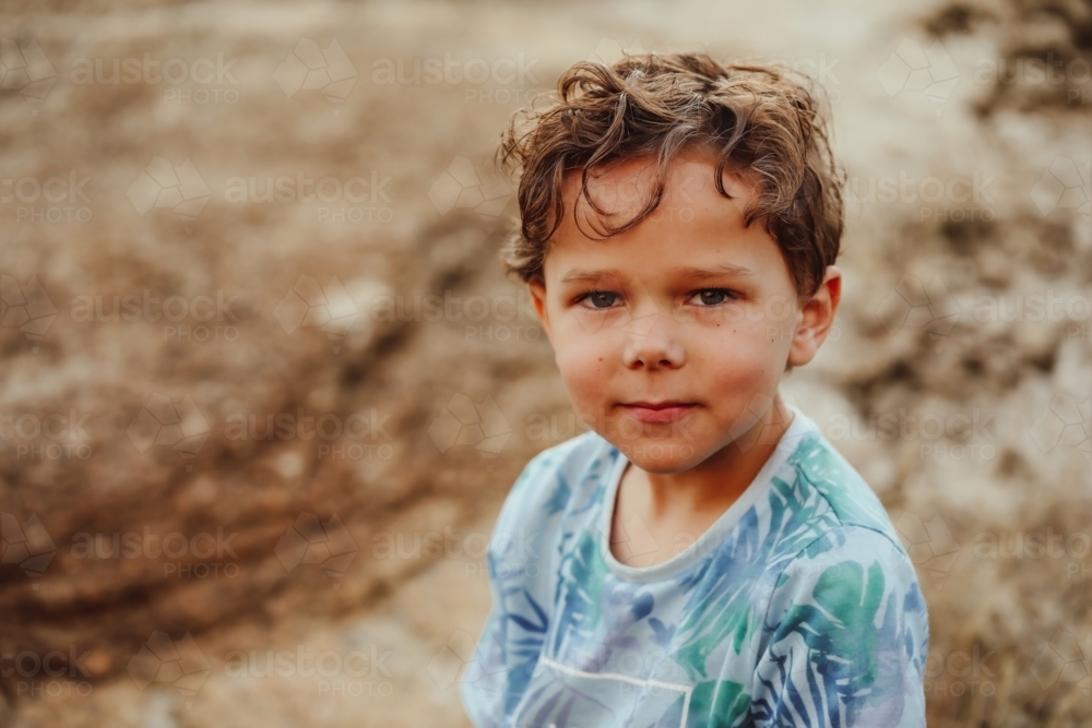 Relaxed portrait of Australian Aboriginal boy in the bush with copy space - Australian Stock Image