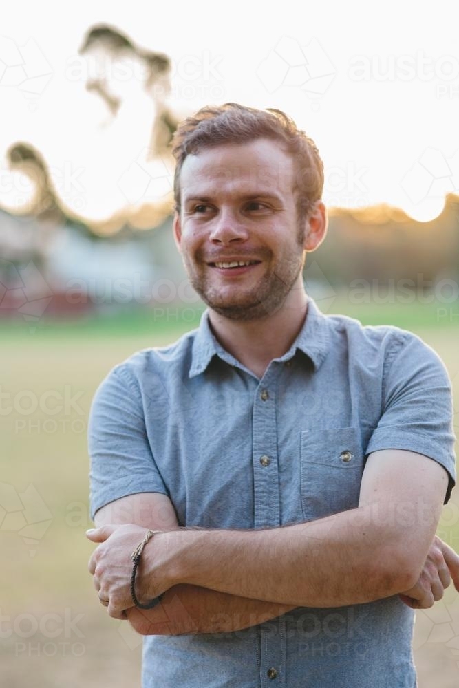 Relaxed smiling man at dusk - Australian Stock Image