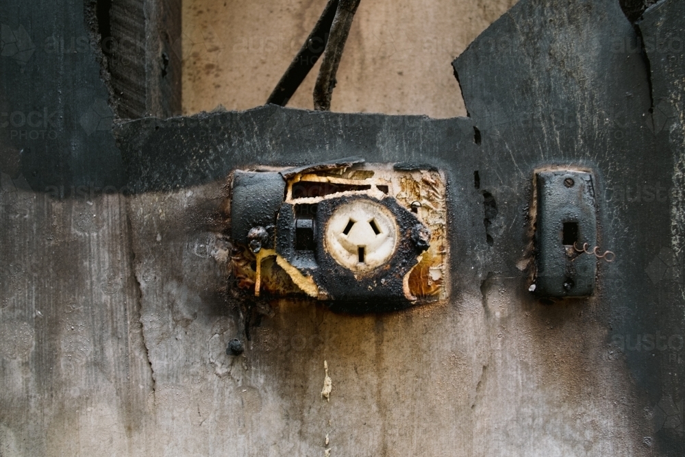 Image of Remains of burnt out electrical plug in a burnt home