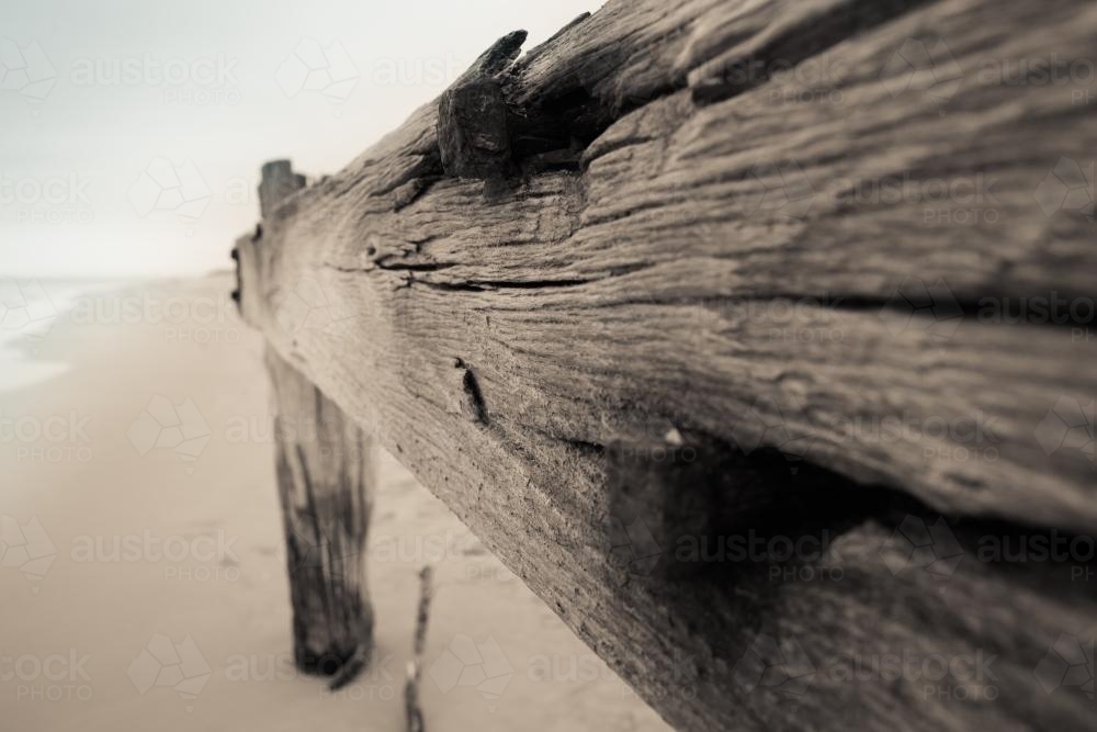 Remnants of a pier on a deserted beach - Australian Stock Image