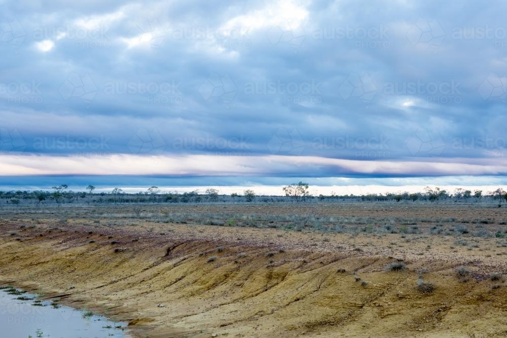 Remote barren landscape with empty dam - Australian Stock Image