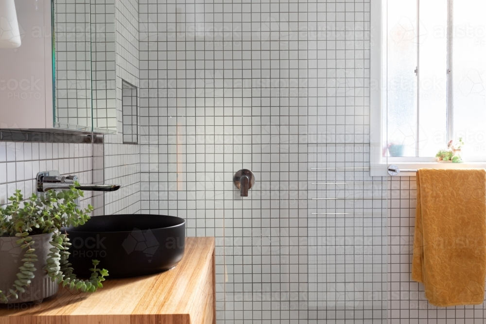 Renovated bathroom straight on shot of shower and sink - Australian Stock Image