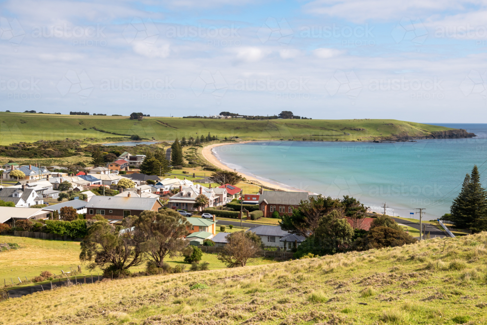 Residential houses along the coast with hills and valleys on a distance - Australian Stock Image