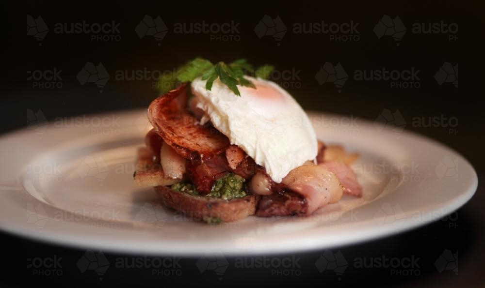 Restaurant breakfast of egg and bacon on toast - Australian Stock Image
