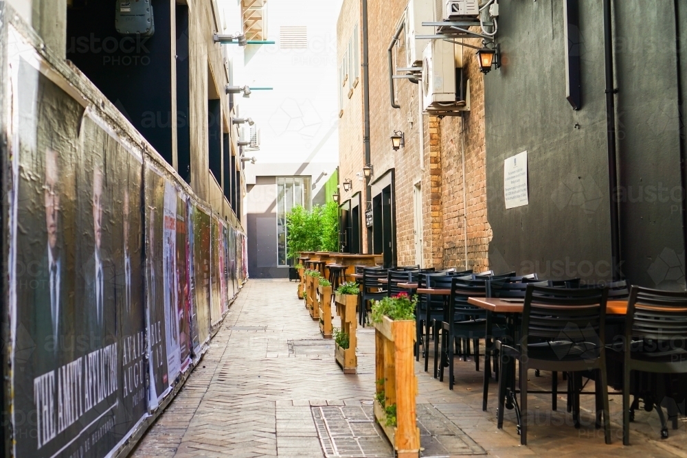 Image of Restaurant seating in the alleyway - Austockphoto