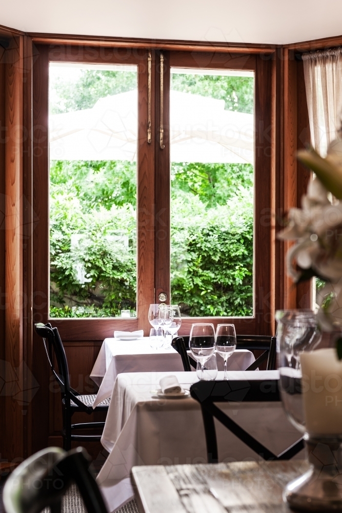 restaurant with table overlooking garden - Australian Stock Image