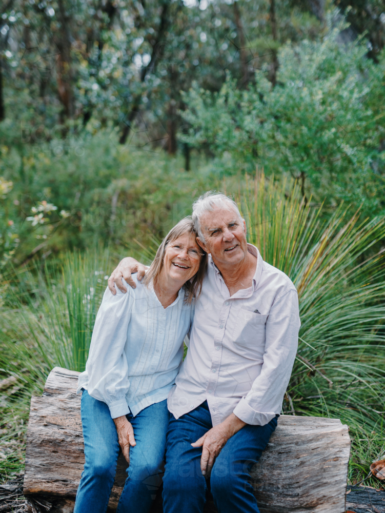 Retired senior couple sitting together enjoying healthy lifestyle in nature - Australian Stock Image