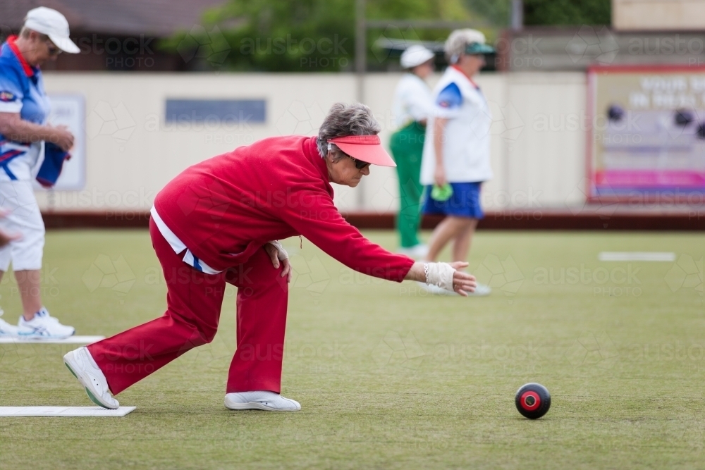Retiree delivering a lawn bowl - Australian Stock Image