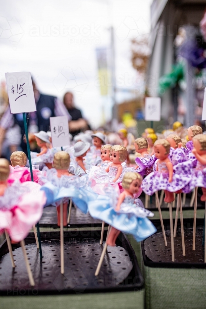 Retro kewpie dolls on sticks for sale at a fair - Australian Stock Image