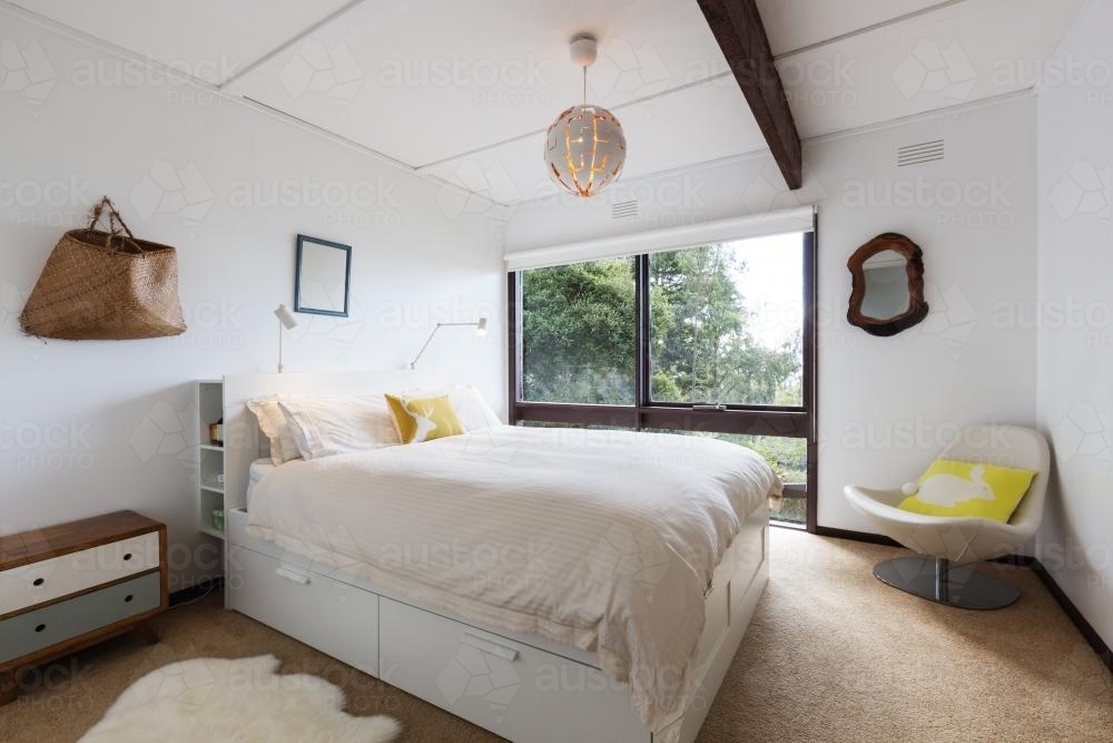 Retro styled guest bedroom in a 70s beach house shack - Australian Stock Image