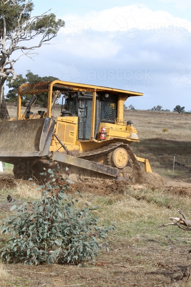 Image of Ripping rabbit burrows - Austockphoto