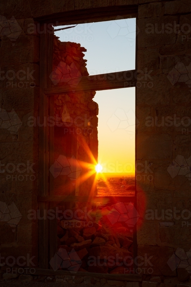 rising sun through window in a ruin - Australian Stock Image