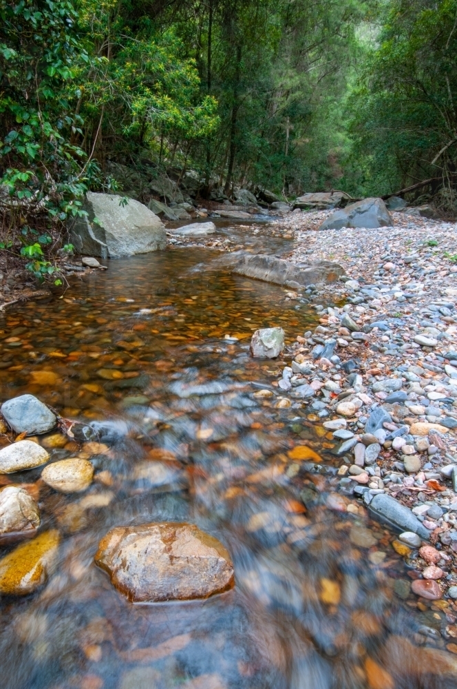 River flowing over a rocky boulder bottom - Australian Stock Image