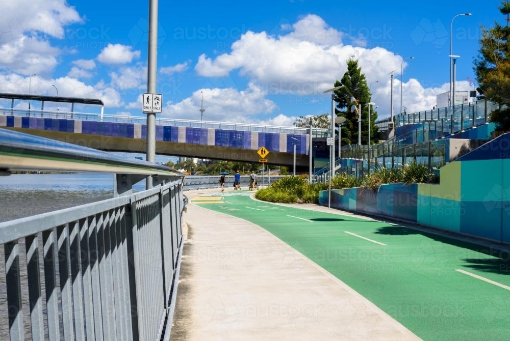 Riverside shared pathway with pedestrians pushing prams in the background - Australian Stock Image