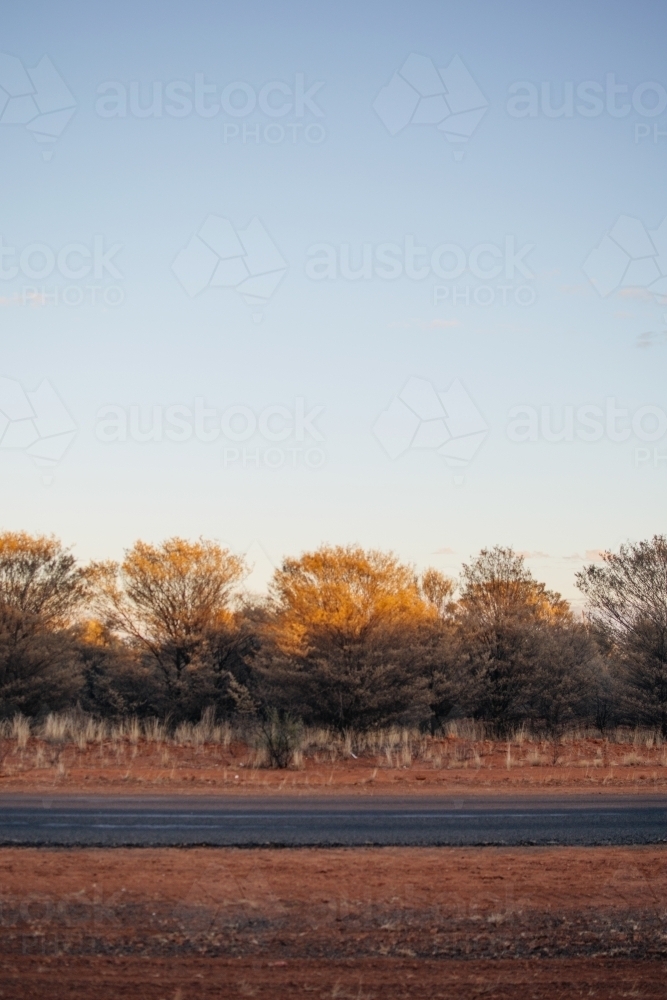 Road against a red dirt landscape - Australian Stock Image