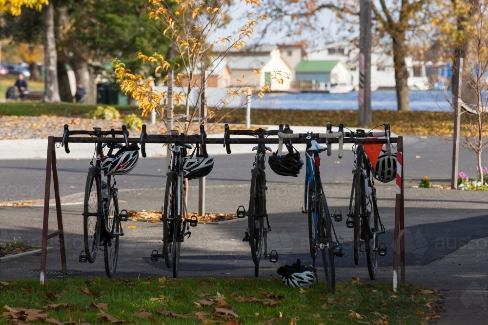road bikes and helmets on a rack outside a cafe - Australian Stock Image