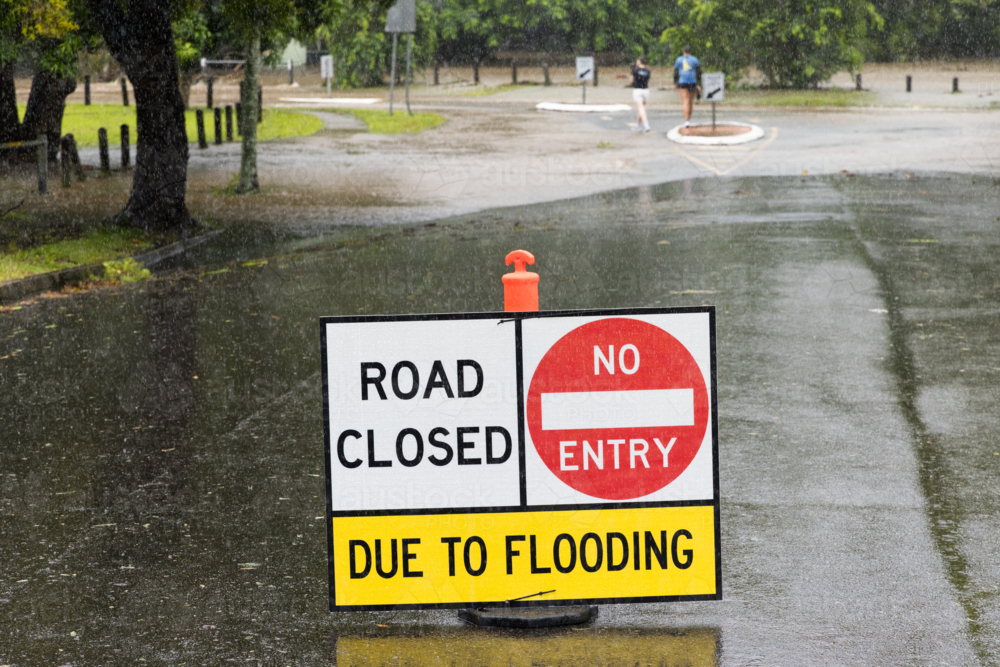 Road closed due to flooding sign on a suburban street in Brisbane - Australian Stock Image