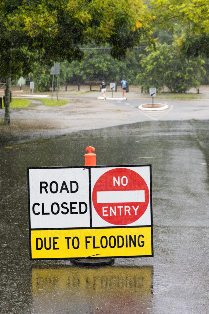 Road closed due to flooding sign on a suburban street in Brisbane - Australian Stock Image