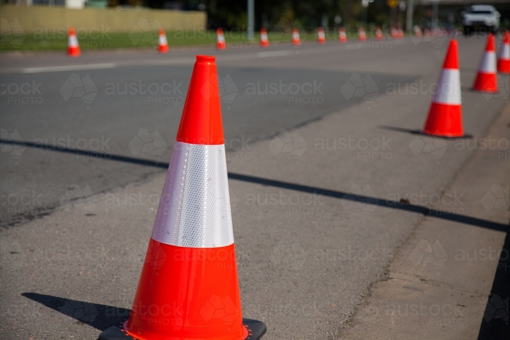 Road cones along a road to stop people parking  for a parade - Australian Stock Image