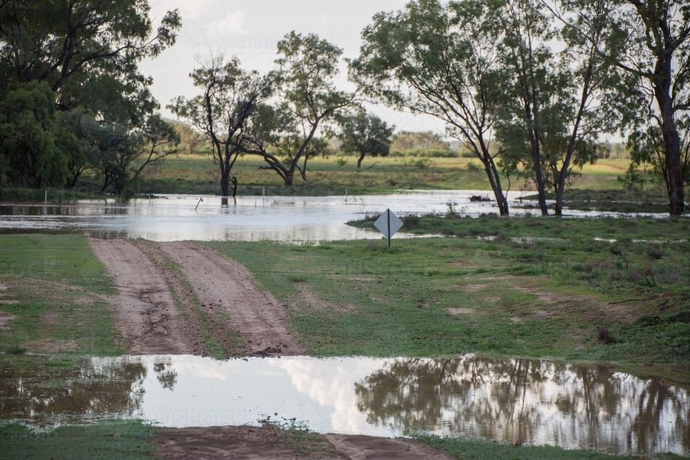 Road cut from flooded creek - Australian Stock Image