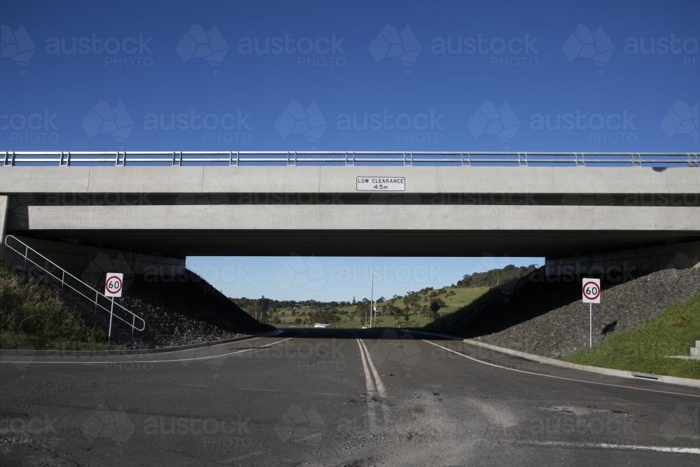 Road going under overpass with low clearance - Australian Stock Image