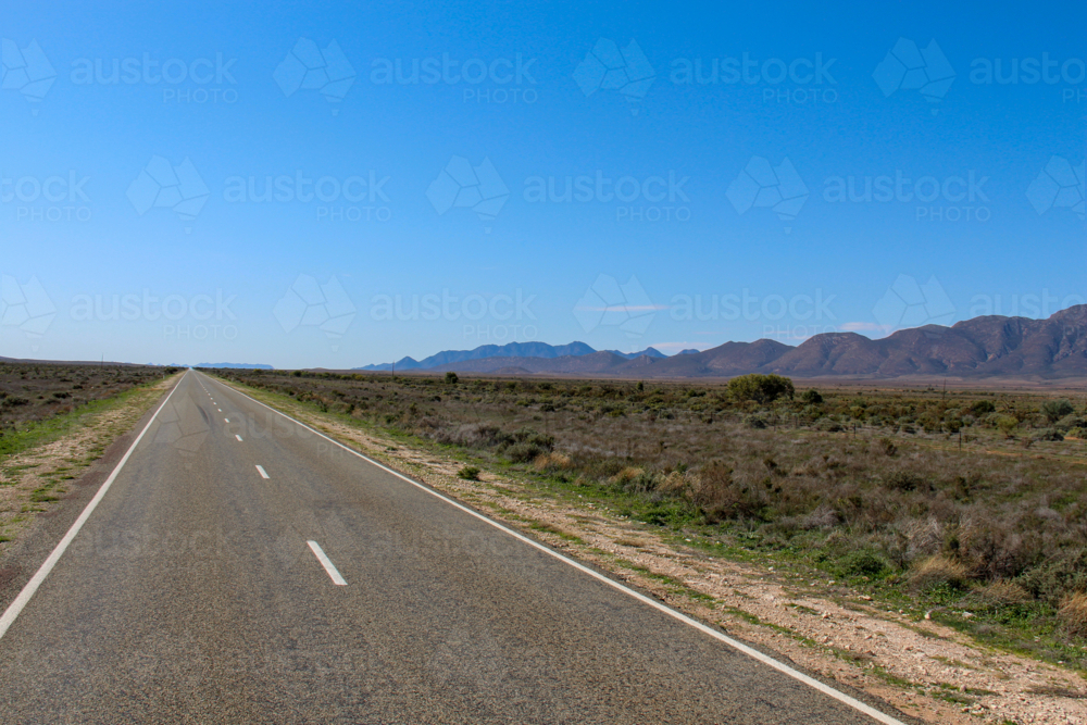 Road into the distance along ranges - Australian Stock Image