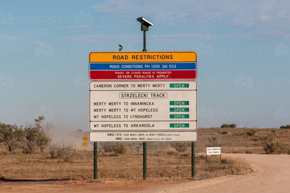 Road restrictions sign next to dirt road - Australian Stock Image
