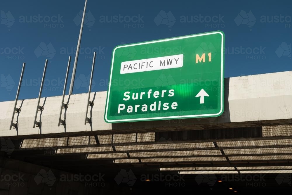 Paradise Rd Sign Image of Road sign pointing to Surfers Paradise, Qld - Austockphoto