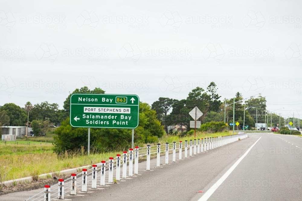 Road sign showing way to Nelson Bay on B63 road and arrow to Port Stephens Dr - Australian Stock Image