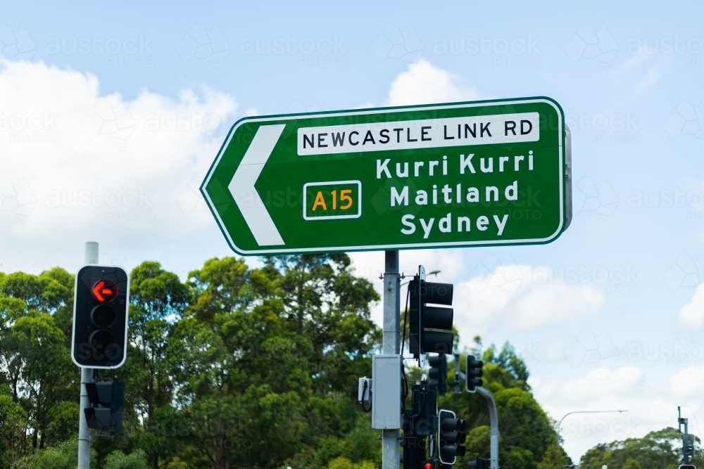 Road sign with directions to Newcastle Link Road at traffic lights - Australian Stock Image