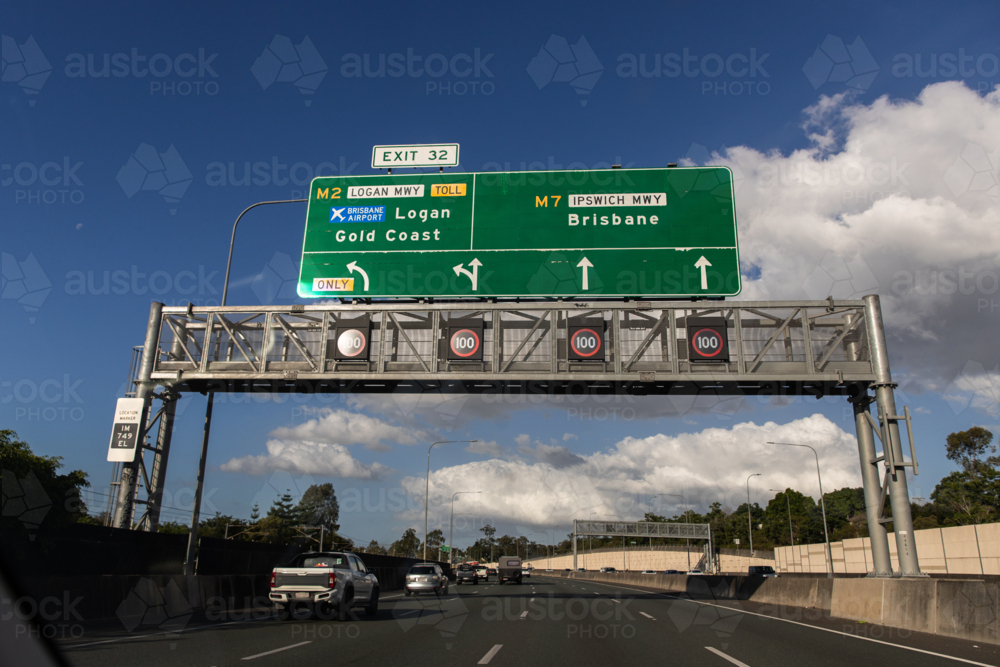 road signs over the motorway heading towards Brisbane or the Gold Coast - Australian Stock Image