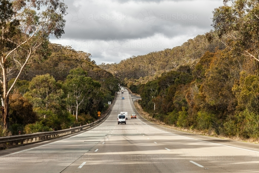 road surveying vehicle driving on one way highway road through australian bushland - Australian Stock Image