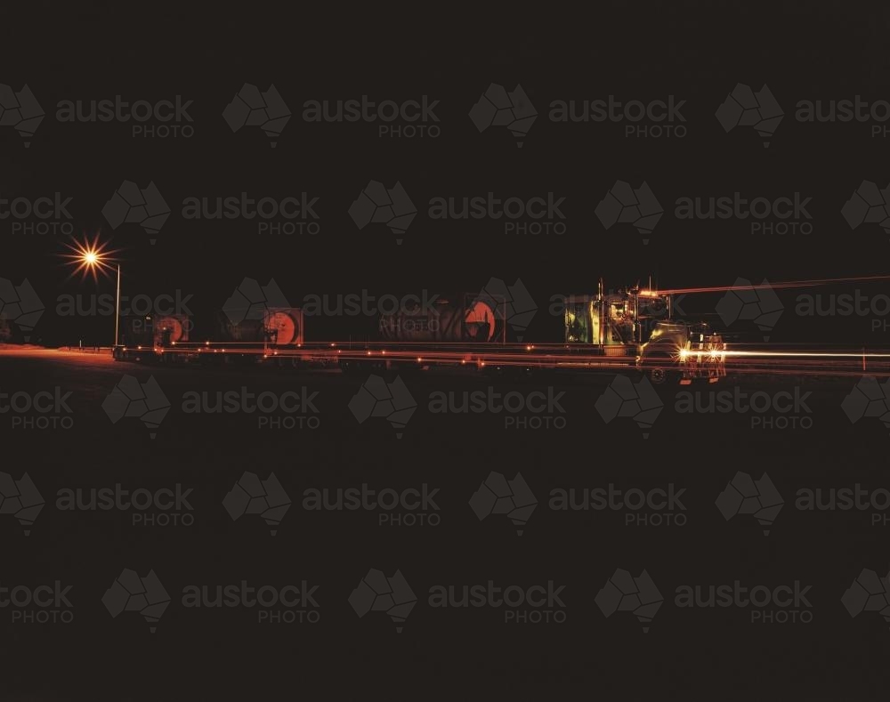 Road train at night with light trails - Australian Stock Image