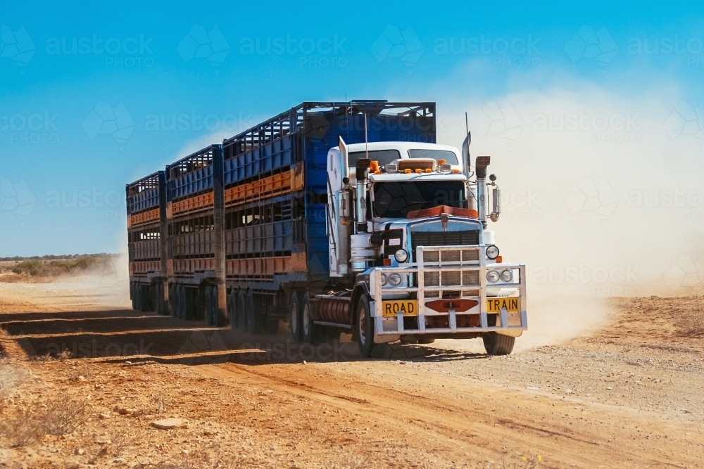 Road train in the Outback on a dirt road - Australian Stock Image