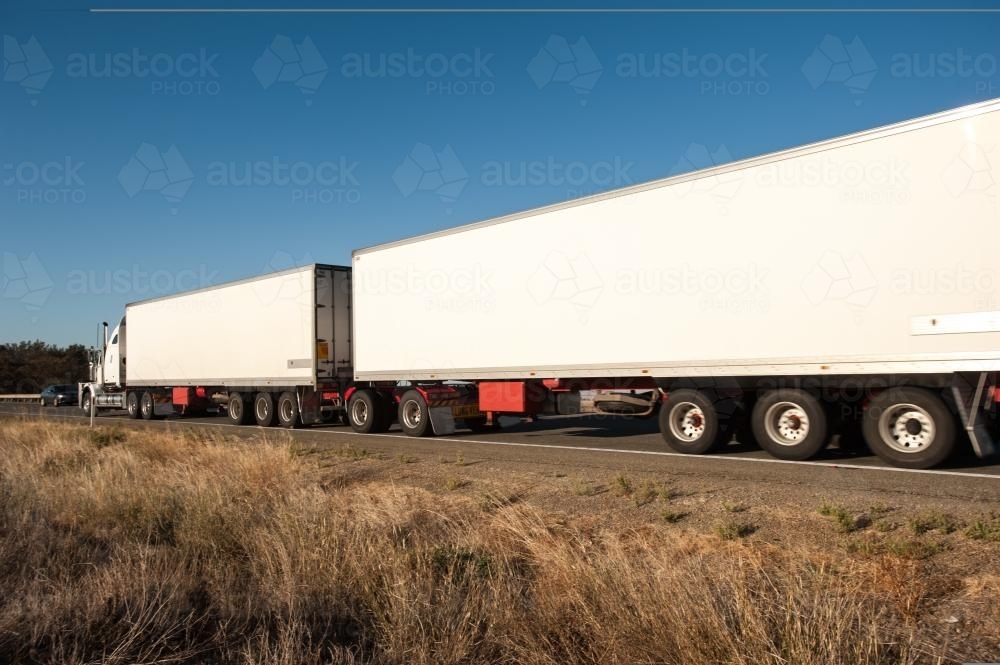 road train, long truck on a highway, blank for copy - Australian Stock Image