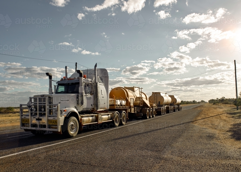 Road Train passing through a country town - Australian Stock Image